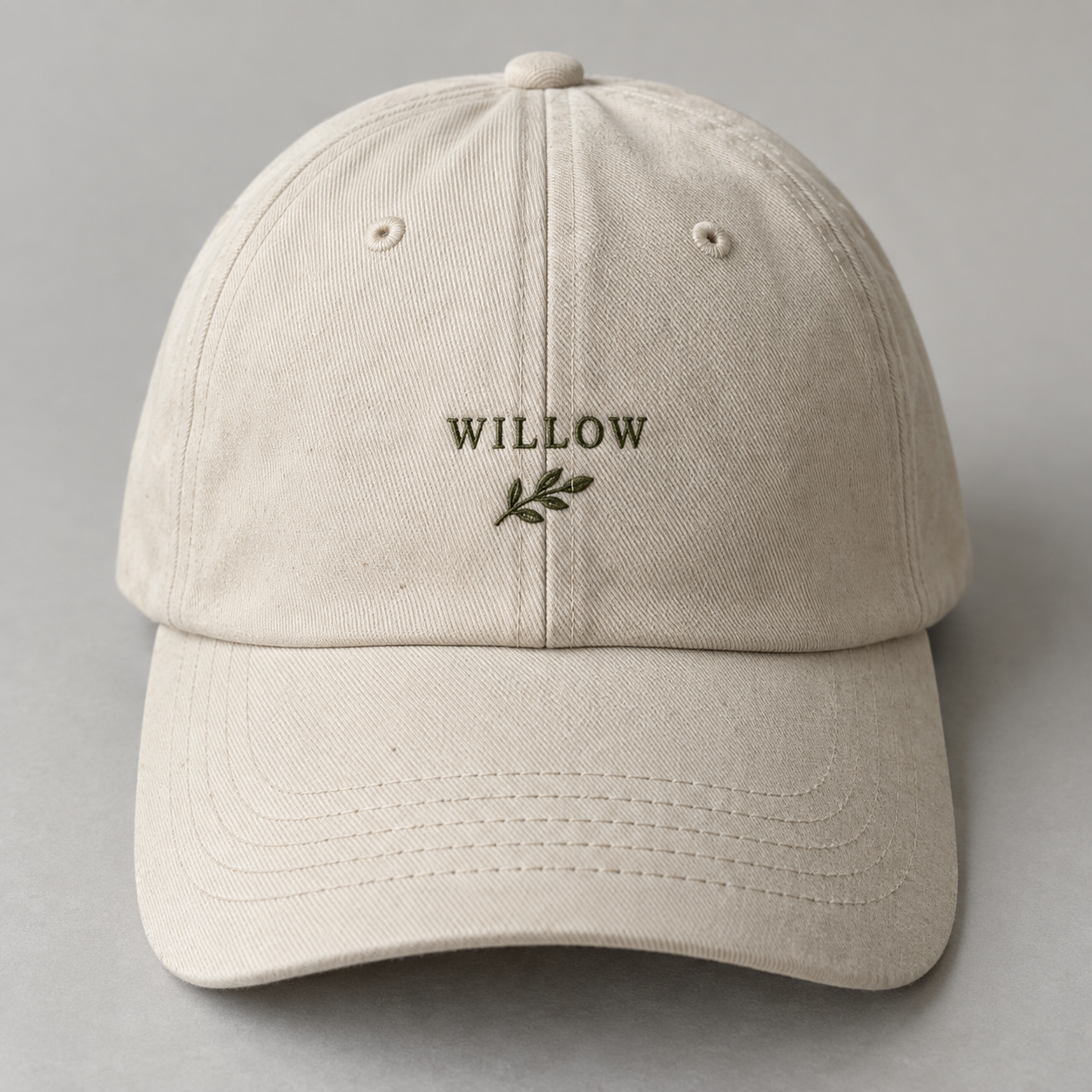 Sample oatmeal cap with Willow lettering and an embroidered sprig